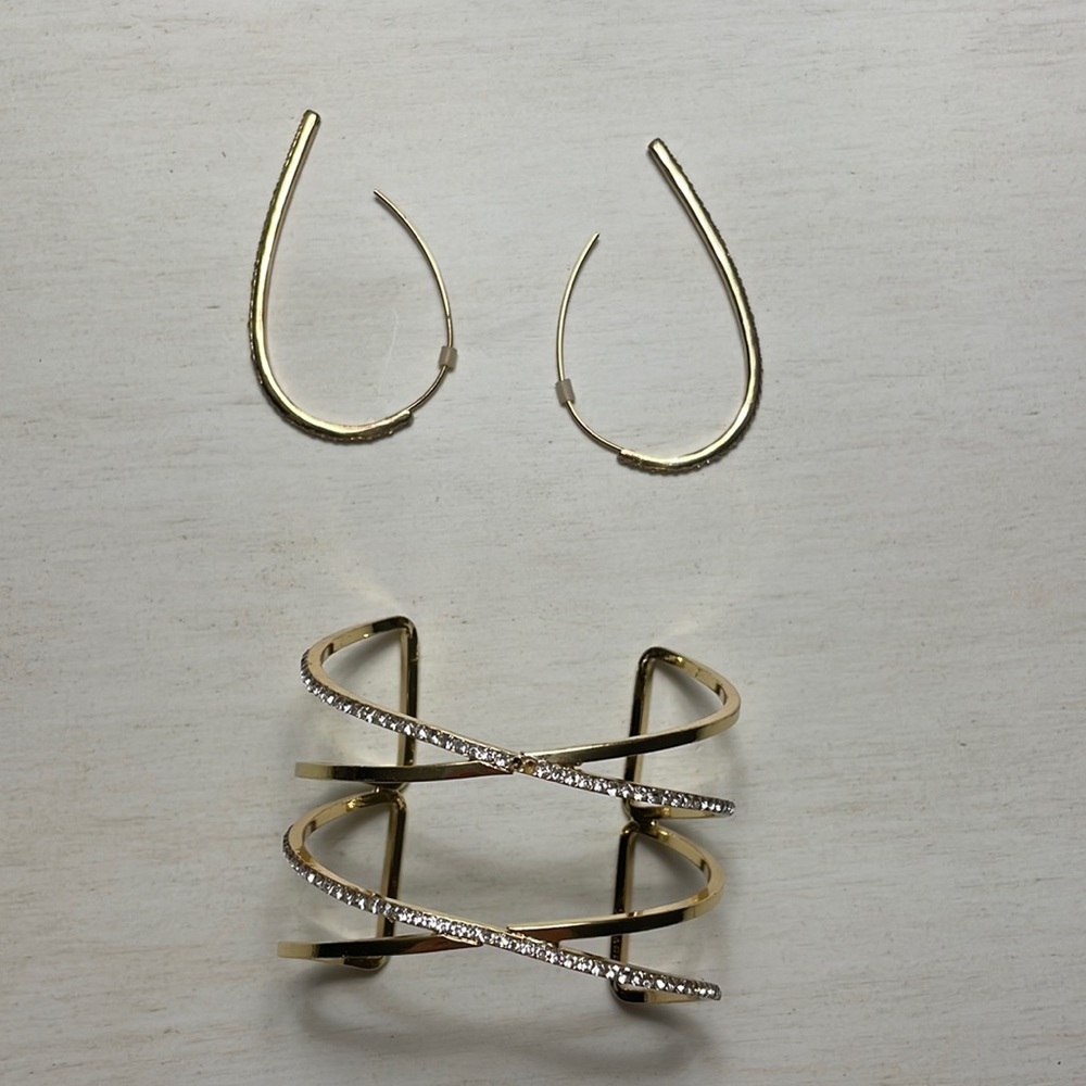 Matching gold earrings and bracelet set.